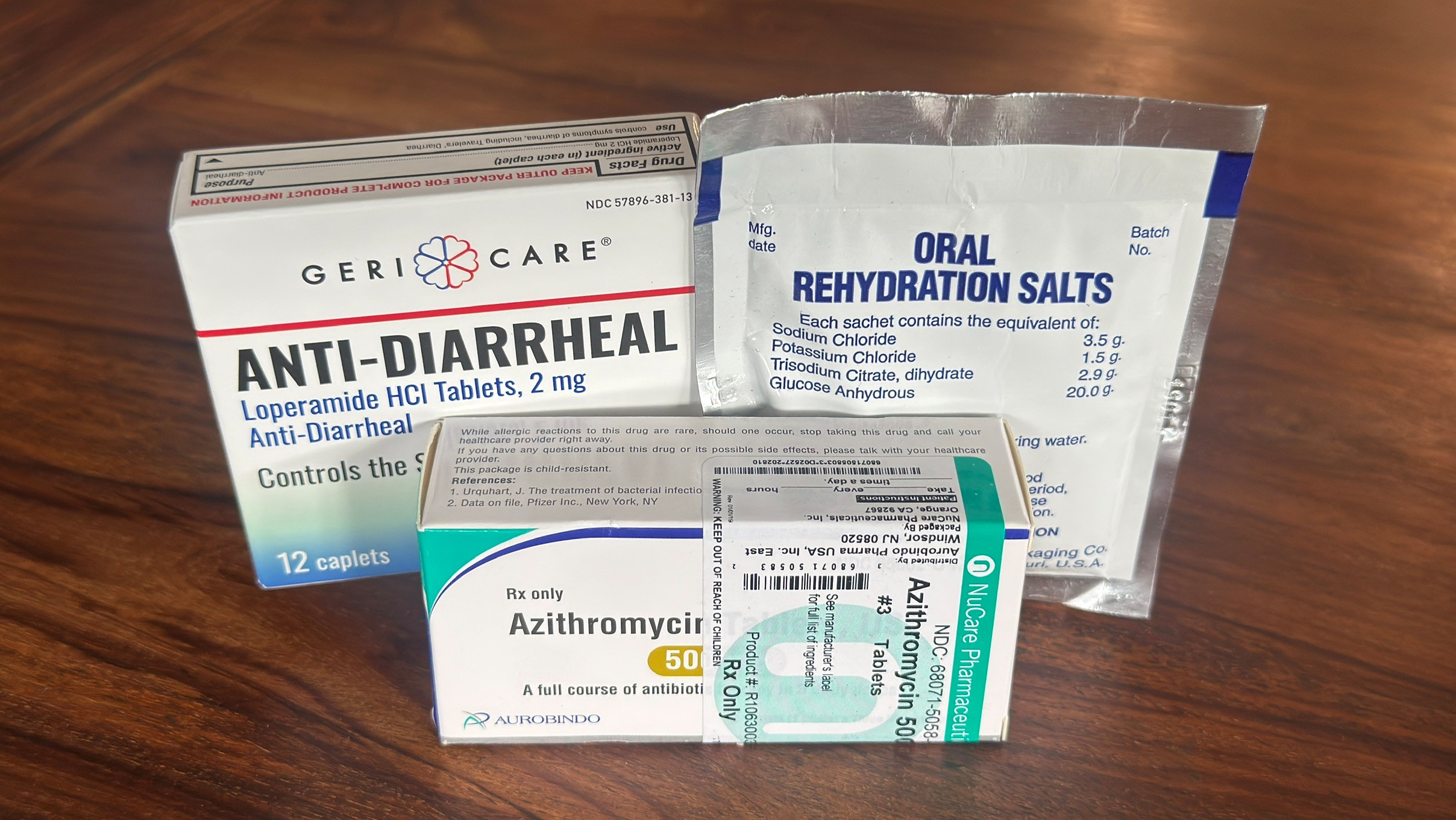 Oral rehydration salts, antibiotics, and diarrhea medication arranged in a travel first aid kit